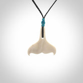 Hand carved bone whale tail pendant. Unisex necklace hand carved by Andrew Doughty here in New Zealand. Unique art to wear. Delivered with an adjustable black cord.